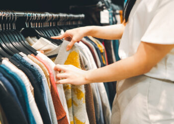 A woman shopping at a used clothing store (iStock image)