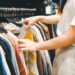 A woman shopping at a used clothing store (iStock image)