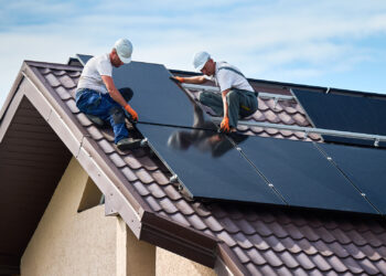 Workers install solar panels on a home (iStock image)