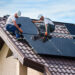 Workers install solar panels on a home (iStock image)