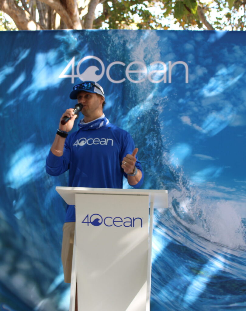 Alex Schulz, co-founder and CEO of 4ocean, speaks at the beach cleanup event Friday at Spanish River Park in Boca Raton. (Benjamin Mostow photo)