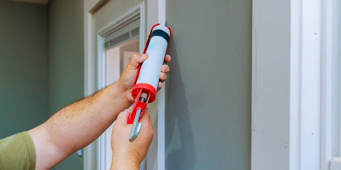 Putting caulking around doors is among the ways to weatherize a home and improve energy efficiency. (iStock image)
