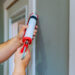 Putting caulking around doors is among the ways to weatherize a home and improve energy efficiency. (iStock image)