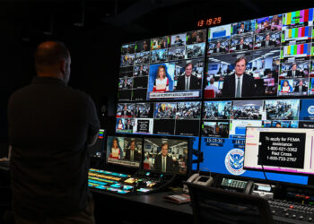A federal official participates in a live news interview about Hurricane Helene relief during a visit to the Federal Emergency Management Agency in Washington, D.C., in 2024. (USDAgov, Public domain, via Wikimedia Commons)