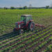 A farmer tills a field of organic soybeans (iStock image)