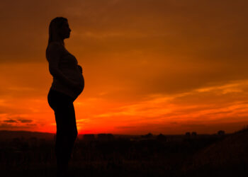 A silhouette of a pregnant woman outdoors (IStock image)