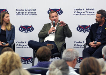 Joshua Voss (center) speaks during the panel discussion while Molly Moynihan (left), and Steven Vollmer (right) listen. (Zach Greathouse photo)