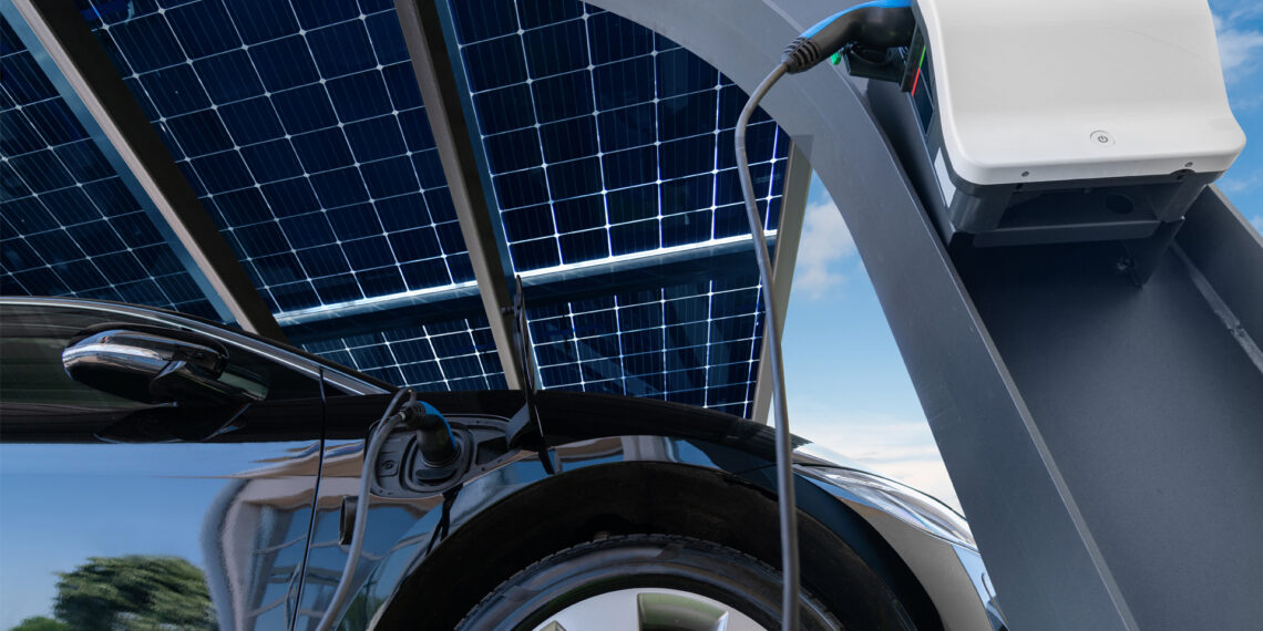 An electric vehicle charging from solar panels (iStock image)