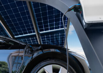 An electric vehicle charging from solar panels (iStock image)