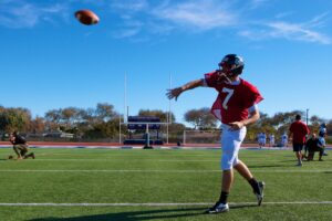A high school football player performs passing drills in Florida. Florida is among the states where tragic heat-related deaths in recent years have spurred policy changes. (Sgt. Scott Schmidt, Public domain, via Wikimedia Commons)