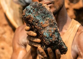 An artisanal miner holds a cobalt stone at a mine near Kolwezi, Congo, in 2022. About 20,000 people work there among toxic materials. (Junior Kannah/AFP via Getty Images)