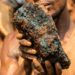 An artisanal miner holds a cobalt stone at a mine near Kolwezi, Congo, in 2022. About 20,000 people work there among toxic materials. (Junior Kannah/AFP via Getty Images)