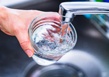 Water being poured into a glass from a faucet (iStock image)