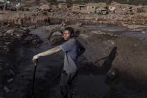 A family works at an artisanal cobalt and copper mine site in 2025 in Kolwezi, Democratic Republic of the Congo. These mines are often unregulated. (Michel Lunanga/Getty Images)