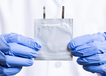 Doctoral student Peng Wang holds an aqueous zinc-ion battery. (Scott Holstein/FAMU-FSU College of Engineering)