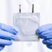 Doctoral student Peng Wang holds an aqueous zinc-ion battery. (Scott Holstein/FAMU-FSU College of Engineering)