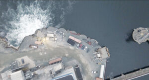 Planetary Technologies’ facility (the small buildings next to the turbulent water) adds magnesium hydroxide to cooling water discharged by a power plant along Halifax harbor. The facility removes an estimated 10,000 metric tons of carbon dioxide from the atmosphere each year. (Credit: Planetary)