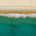 An aerial view of waves hitting a beach (iStock image)