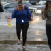 Pedestrians battle the wind, rain and flooded streets in downtown Denver. (Photo By John Leyba/The Denver Post via Getty Images)