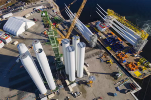 Offshore wind farms bring jobs and economic development. State Pier in New London, Conn., serves as a staging site for wind farm construction and supplies. (AP Photo/Ted Shaffrey)