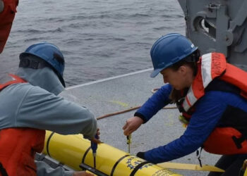 Researchers prepare to deploy a glider instrument into the ocean. (Photo by Rebecca Travis/Woods Hole Oceanographic Institution)