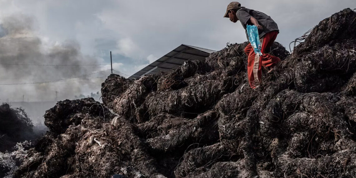 Workers prepare to burn imported plastic waste at a dump in East Java, Indonesia, in 2018. (Ulet Ifansasti/Getty Images)