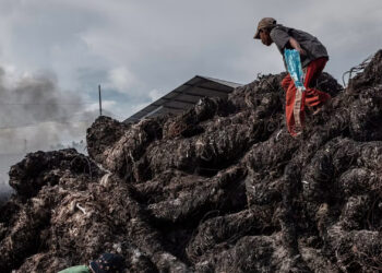 Workers prepare to burn imported plastic waste at a dump in East Java, Indonesia, in 2018. (Ulet Ifansasti/Getty Images)