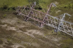 Hurricane Ida crumpled a huge transmission tower carrying high-voltage power lines into New Orleans in August 2021. (AP Photo/Gerald Herbert)