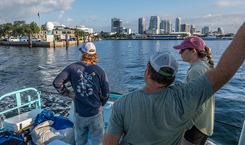 As the boat exits Bayboro Harbor, the crew looks back at the damaged Marine Science Laboratory. (Photo by Jackson Sullivan)