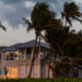 Wind blows palms in front of a Florida home (iStock image)